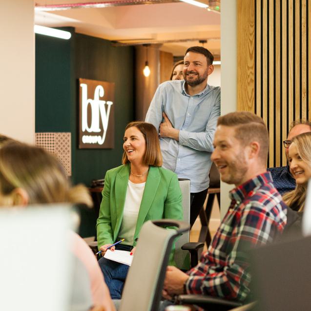 Members of the BFY Group team sat together in the BFY office.