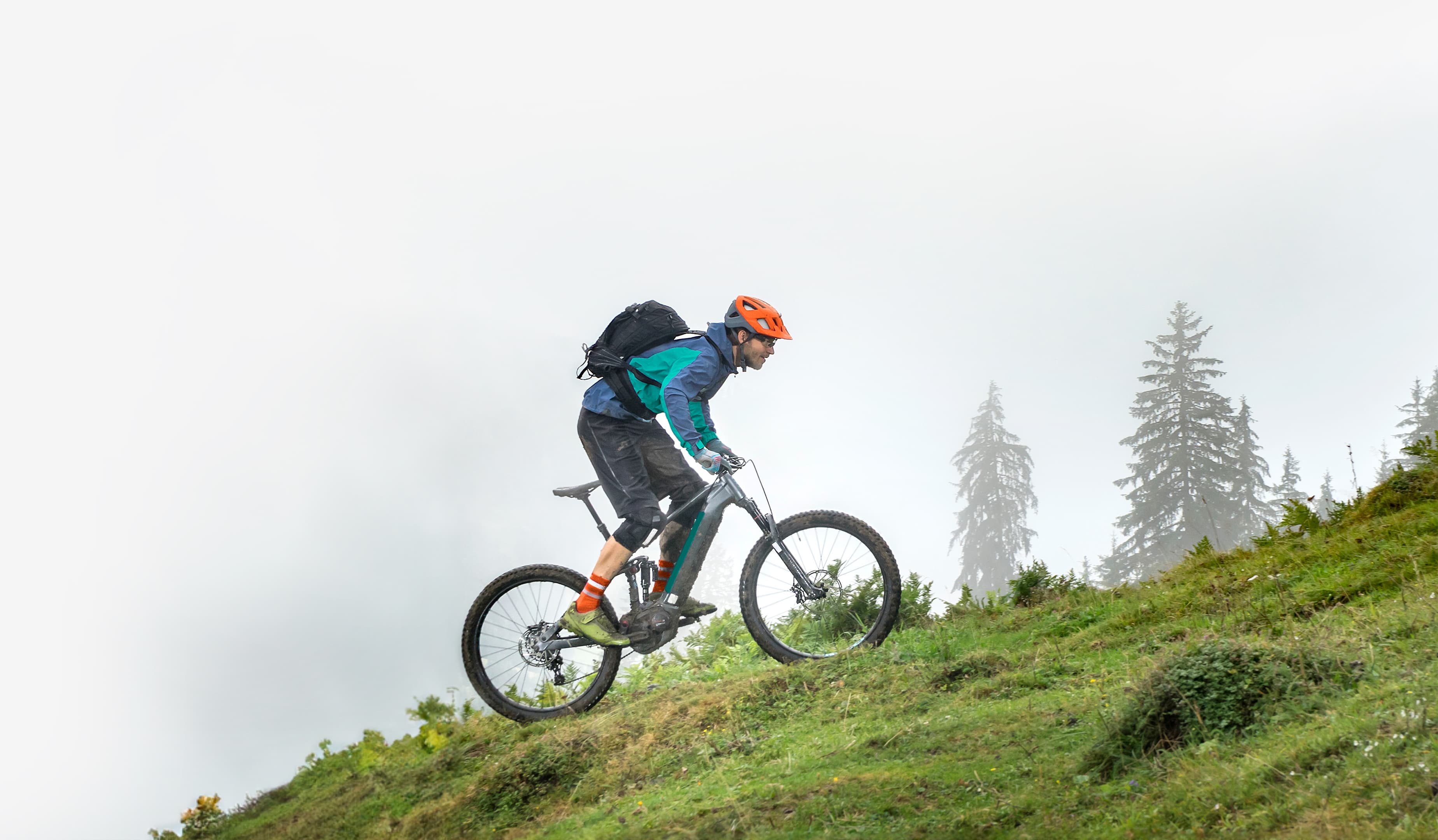 Man riding upwards on a steep hill on a mountain bike.